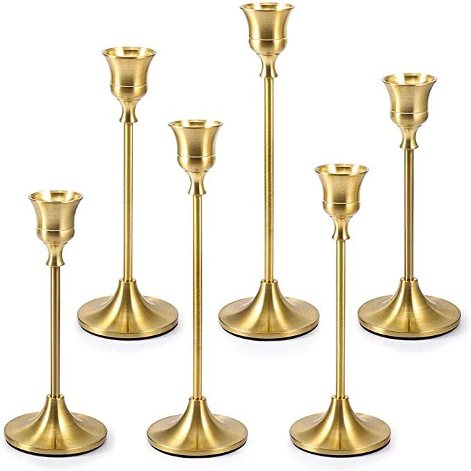 six gold candlesticks on a white background