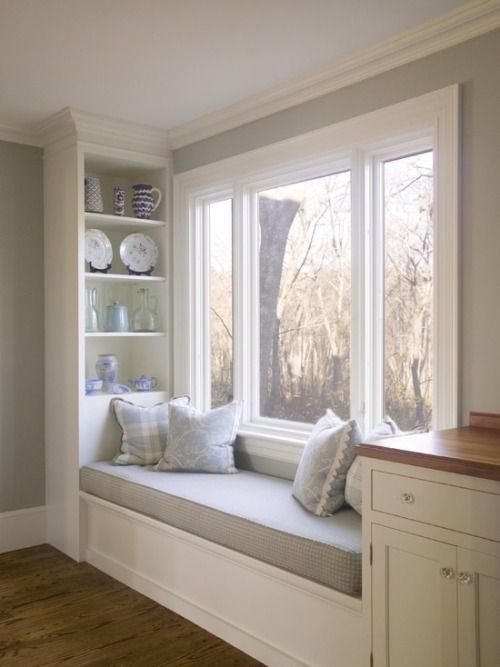 a window seat in the corner of a room