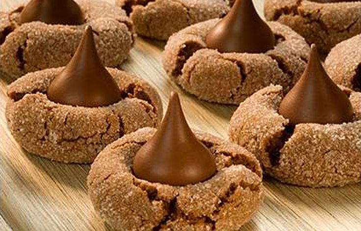 several cookies with chocolate frosting on a wooden table