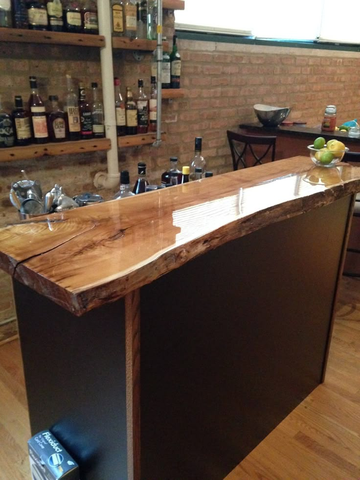 a wooden bar with bottles on the shelves