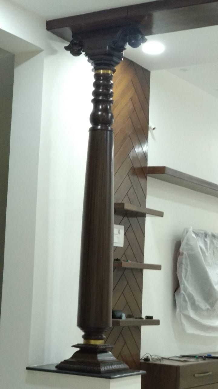 a tall wooden pole sitting in the middle of a room