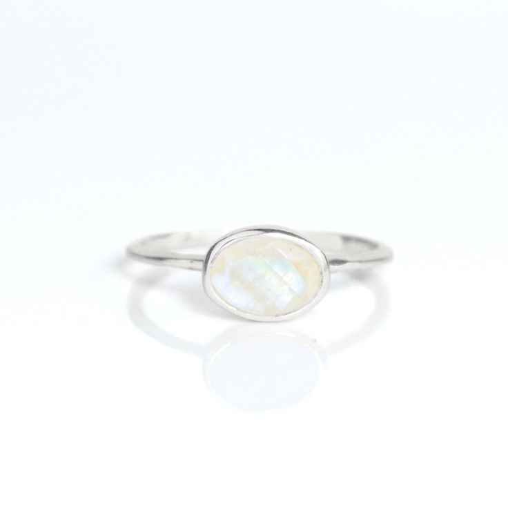 You'll fall in love with an iridescence of this Rainbow Moonstone ring. This is a perfectly sized oval to compliment any collection. Popular as a birthday gift for those June babes and Rainbow Moonstone lovers alike. This stone is beautifully faceted and bezel set in a 925 sterling silver band or plated with 18k vermeil gold. Gemstone is approximately 8 x 6mm.Band has 925 stamp on inside.Please note that each ring is handmade and there may be some slight variations from listing photo.Available i Oval Birthstone Ring Gift, Sterling Silver Oval Moonstone Birthstone Ring, Oval Moonstone Birthstone Ring In Sterling Silver, Oval Moonstone Gemstone Ring, White Oval Faceted Ring, Oval Moonstone Birthstone Ring Gift, White Oval Moonstone Birthstone Ring, Oval White Moonstone Birthstone Ring, Oval Opal Birthstone Ring For Gift