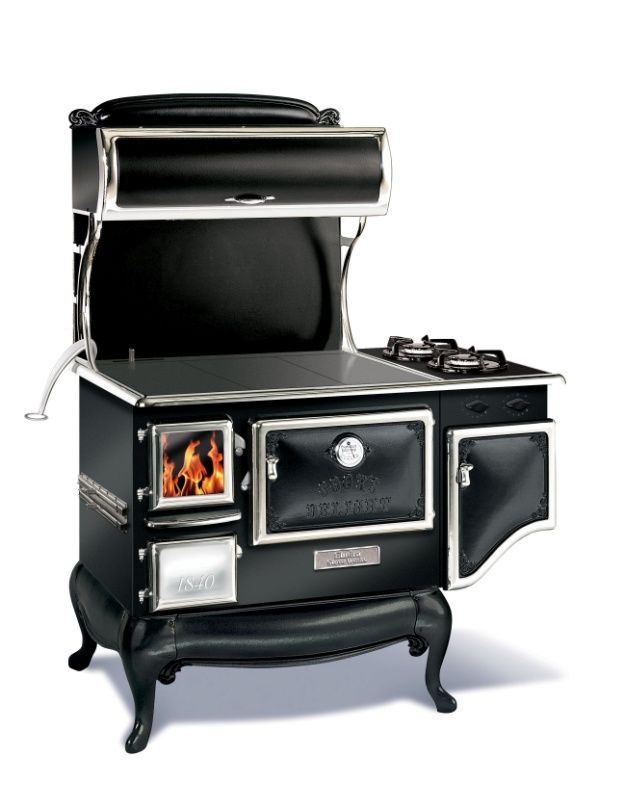 an old fashioned stove with the door open and flames in it's burners