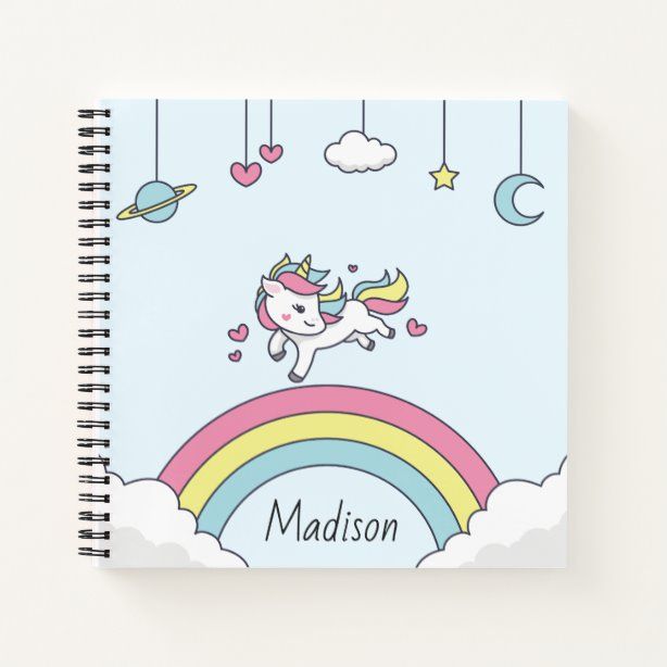 a spiral notebook with an image of a unicorn flying over the clouds and rainbows