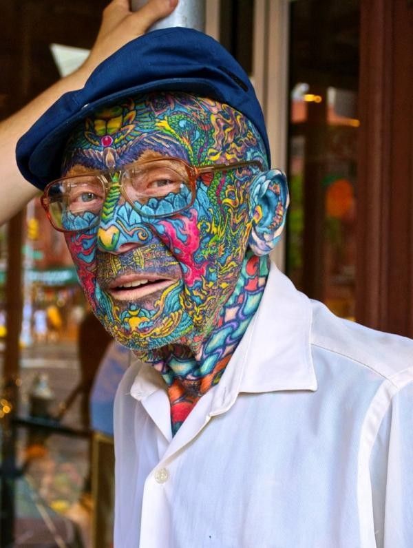 an old man with colorful face paint on his face