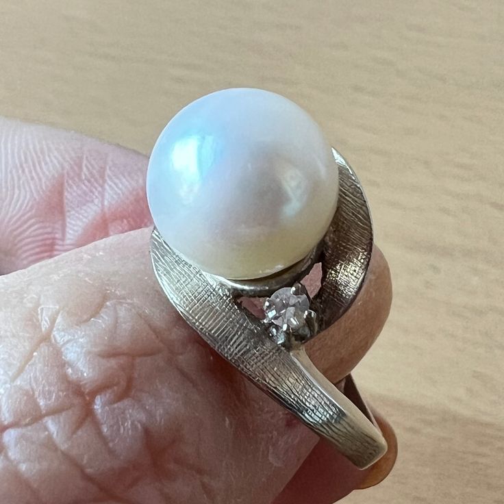 Stunning Vintage Ring In Solid 14k White Gold ( Stamped & Tested). When I Purchased It At The Rstate Sale, I Loved Everything About This Ring: The Heafty Chunky Setting, The Sparkling Diamonds On The Side, But The Pearl Was Dull So, My Jeweler Sent Me To The Pearl Wholeseller In The Nyc Jewelry District And Together We Chose This Beautiful, Round, White, Large 10mm Pearl For This Setting. When My Jeweler Set This New Pearl Into This Beautiful Vintage Setting, Its As If She Was Always There : A Perfect Match !!! Each Side Diamond Is Approx 2.3 Mm In Size , Genuine, Tested, I Do Not Have Color/ Clarity Info. Naked Eye Very Sparkly!!! So, This Is Truly A One Of A Kind Ring !!! Timeless Pearl Ring With Diamond Accents For Anniversary, Timeless Anniversary Pearl Ring With Diamond Accents, Classic Diamond Pearl Ring For Anniversary, Timeless Pearl Ring With Prong Setting For Anniversary, Classic Pearl Ring With Diamond Accents For Anniversary, Classic White Gold Pearl Ring With Diamond Accents, Fine Jewelry White Gold Pearl Ring With Prong Setting, White Gold Pearl Ring With Prong Setting, Diamond Pearl Ring With Prong Setting For Anniversary