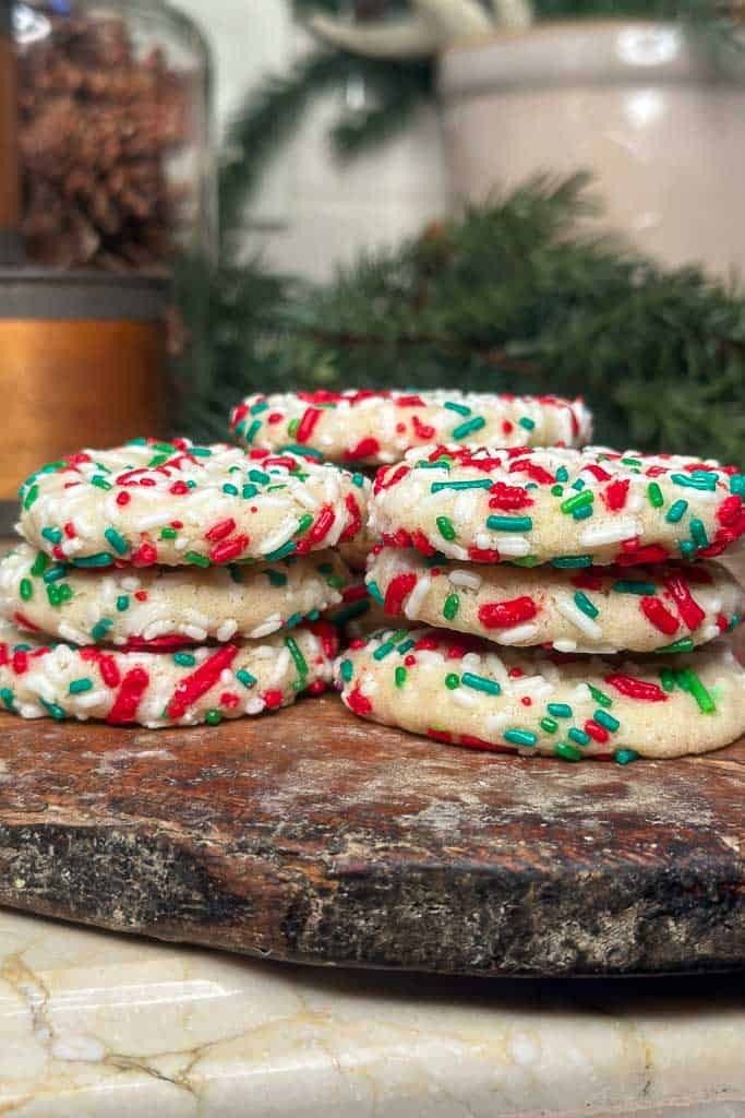 a stack of cookies with sprinkles on top of a marble countertop