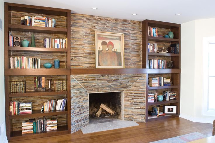 a living room filled with furniture and a fire place in front of a stone fireplace