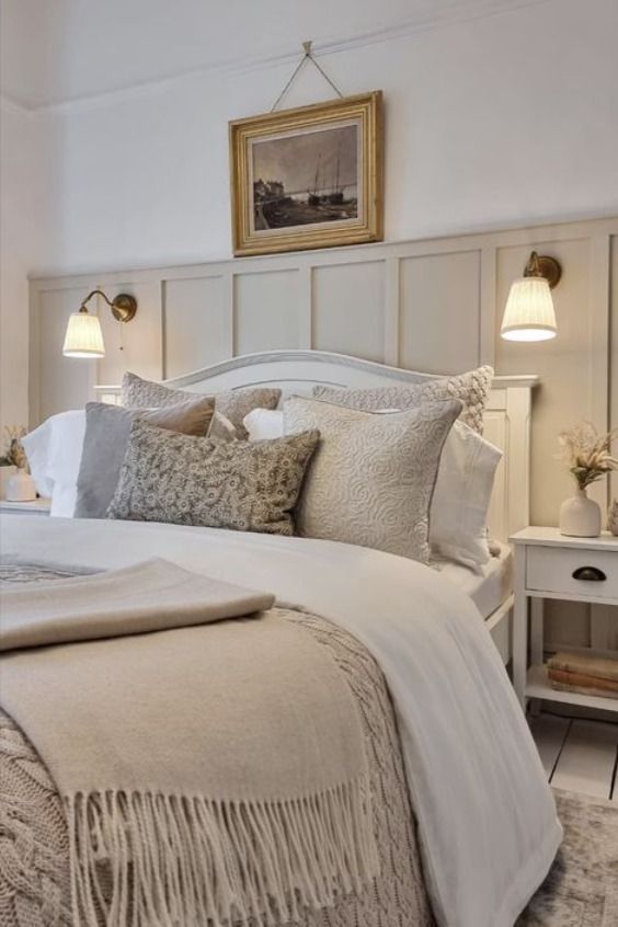 a bed with white linens and pillows in a bedroom