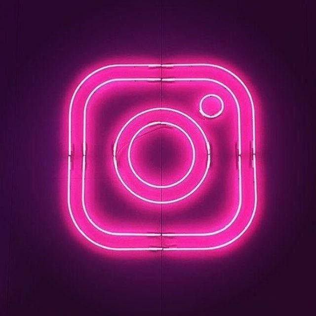 an instagram neon sign on a purple background