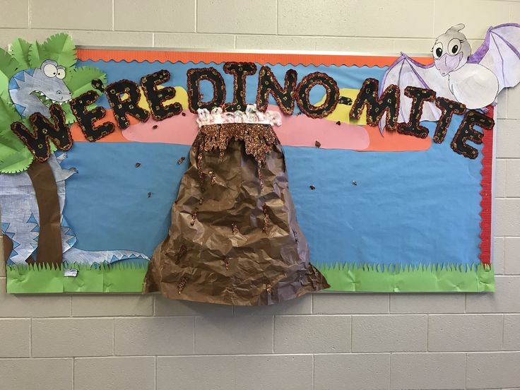 there is a paper bag on the wall next to a sign that says we are dinomite