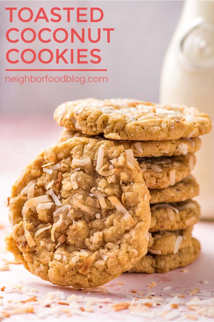 three oatmeal cookies stacked on top of each other next to a bottle of milk