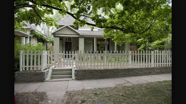 a white picket fence in front of a house