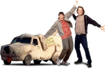 two men standing next to an old car that has been turned into a sheep statue