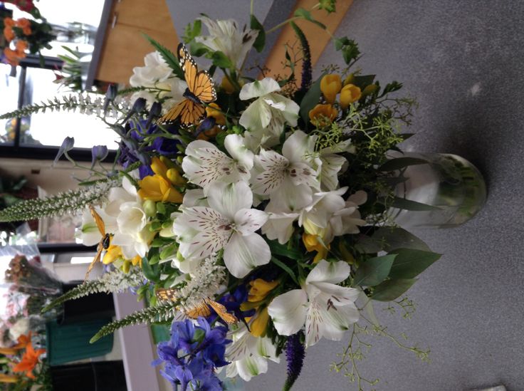 a vase filled with white and blue flowers