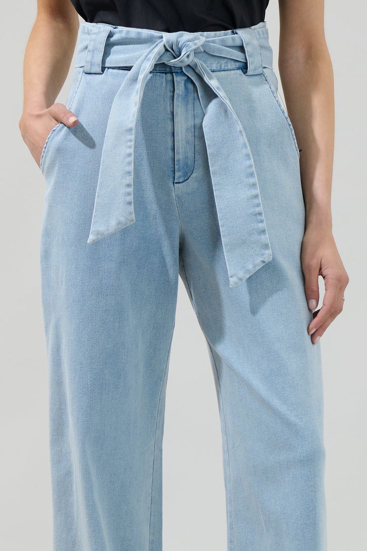 Strike the perfect pose in the June Denim Wanetta Wide Leg Pants! Denim fabric shapes these breezy pants that have a high-waisted fit with belt loops and a sash belt. The wide legs have tailored pleating, side pockets, and end at ankle-length hems. Pair the pants with your favorite blouse, add some heels, and you're all set to go out.- Belted- High waisted- Pockets- Wide leg - Comes in 3 colorsSize + Fit - Model is 5'8" and wearing size XS- Measurements taken from size S - Waist: 13 1/2"- Inseam High-waisted Denim Wide Leg Pants With Belt Loops, High-waisted Denim Blue Wide Leg Cotton Pants, Denim Blue Wide-leg Cotton Pants, Denim Blue Wide-leg Bottoms With Belt Loops, Non-stretch Blue Denim Wide Leg Pants, Denim Cargo Pants, Pants Denim, Sash Belts, Sash Belt