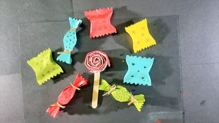 several candy lollipops are arranged in the shape of fish and seaweed