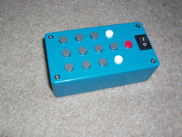 an electronic device sitting on the floor with buttons