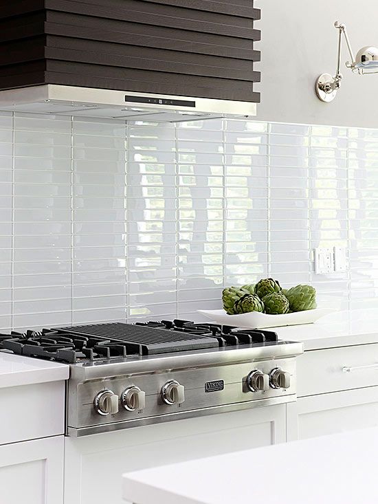 a stove top oven sitting inside of a kitchen next to a counter with vegetables on it