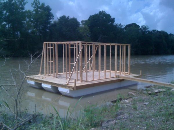 a wooden structure sitting on top of a body of water