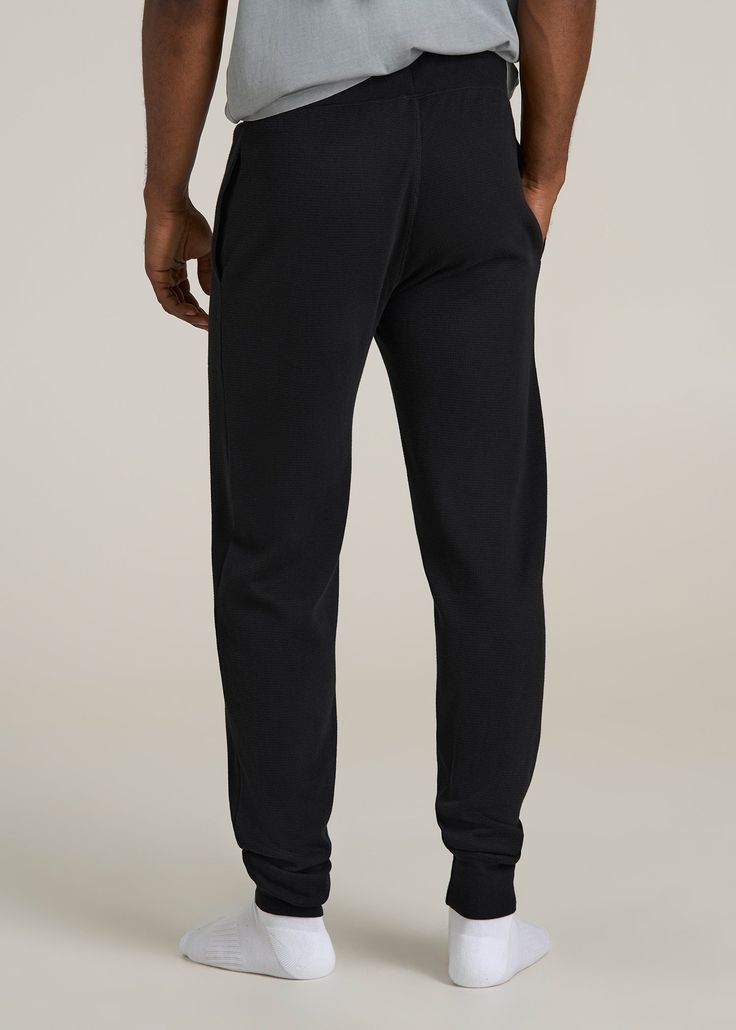 Upgrade Your Loungewear Game Tall Men's Jogger Pants That Fit Just Right Take your loungewear to the next level with our Waffle-Knit Lounge Jogger for tall men. These extra-long men's joggers offer a regular fit with a mid-rise that sits comfortably, and the drawstring waist ensures a secure fit. Side seam pockets add practicality to this essential home wear piece. Perfect for relaxing at home or running errands, these tall joggers combine comfort and functionality tailored for your taller frame Scrubs Dress, Cozy Sleepwear, Mens Jogger Pants, Tall Men, Men In Black, Fall Denim, Home Wear, Sports Blazer, Long Sleeve Tee Shirts