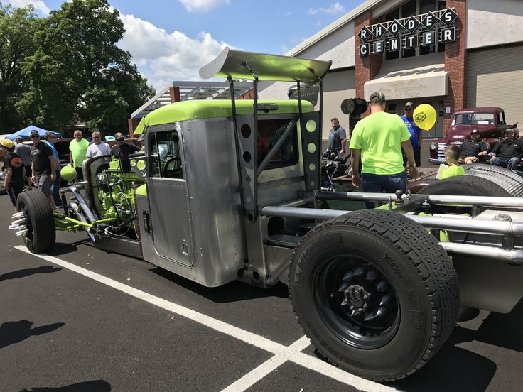 a large truck with people standing around it