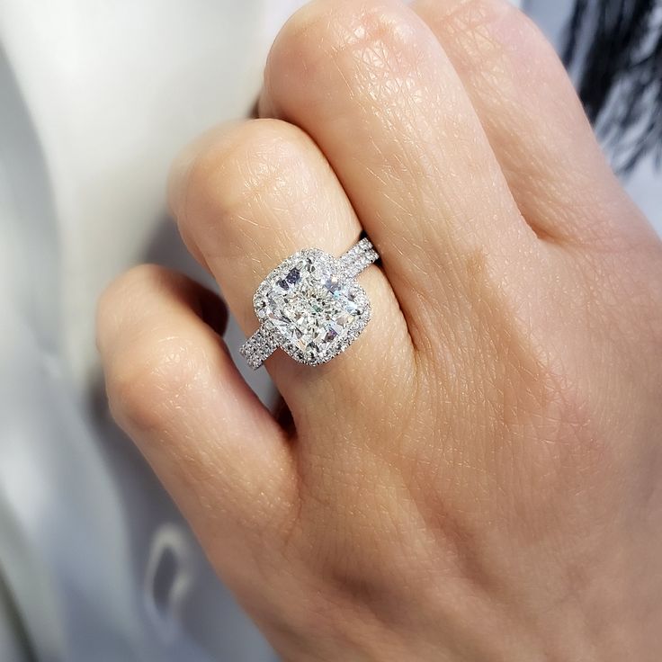 This exceptional diamond engagement features a GIA certified 3.00 Ct. Cushion cut diamond with I color grade and very clean VVS1 clarity. Matching its color and clarity are 0.70 Ct. Round cut diamonds set pave on the halo and flow down the shank in a single row. Matching Band is available by request! Metal : 14K Gold, 18K Gold or Platinum Setting Type : Prong, U-Setting Total Carat Weight : 3.70 Carats Type : Natural Diamond Shape : Cushion Cut Carat Weight : 3.00 Ct. (GIA Certified) GIA Certifi Halo Cushion Cut Engagement Ring, Cushion Cut Halo, Cushion Cut Diamond Engagement Ring, Stunning Diamond Rings, Cushion Cut Diamond Ring, Cushion Cut Engagement, Gia Certificate, Cushion Cut Engagement Ring, Round Diamond Engagement Rings