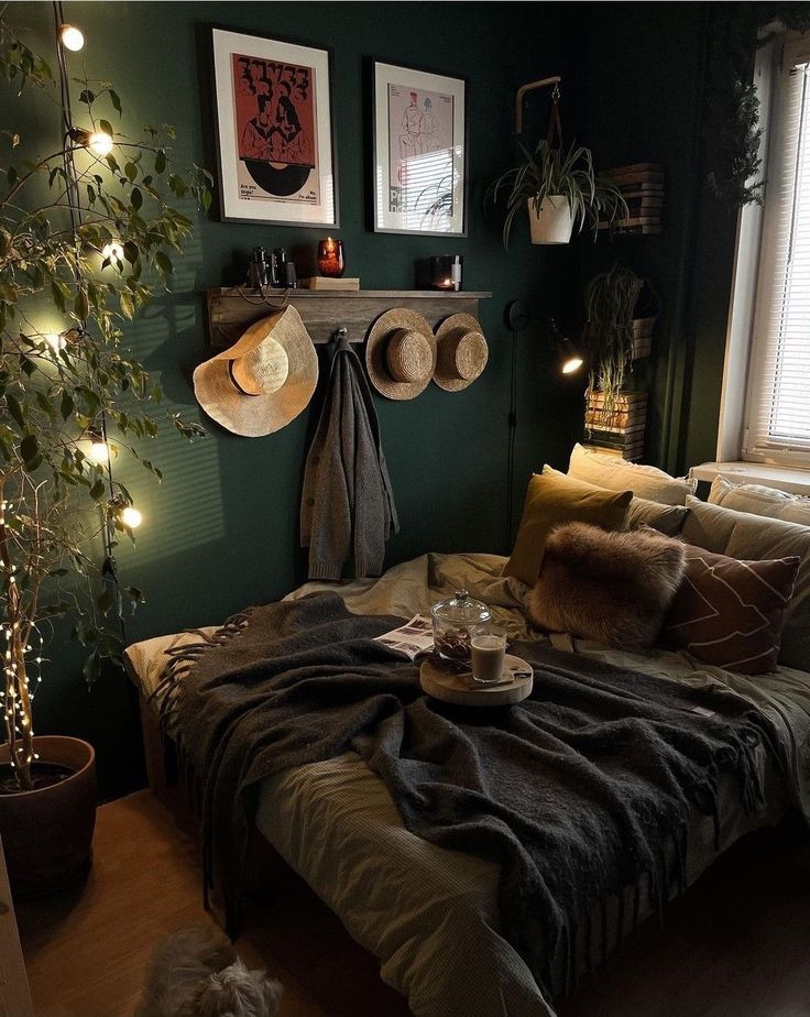 a bedroom with green walls and lights on the wall