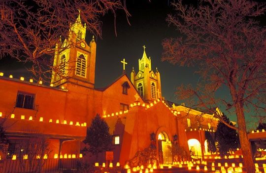 an old church lit up at night with candles