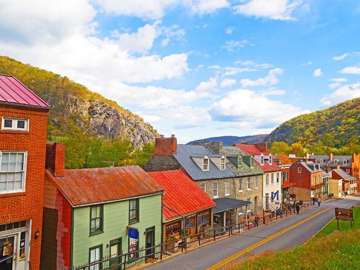 a small town with lots of buildings and mountains in the background