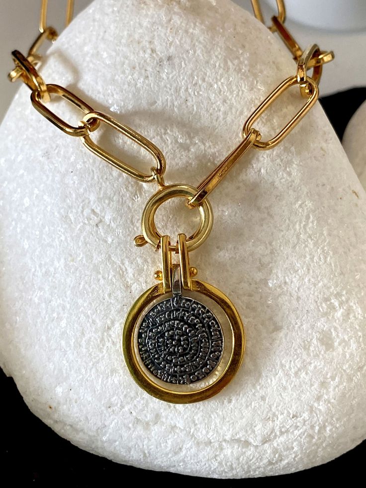 Buy an original Greek Pendant 22k Gold plated Phaistos Disk | Discover Greek Jewelry within a huge collection of Ancient Greek Jewelry | shipping worldwide This amazing piece of jewelry is representing the Ancient Greek Symbol so called Phaistos disc. An excellent gift for women and also for men that would love to wear a geometric symbol. Ideal present for someone who have already spent time in this beautiful island or he comes from this. Size The diameter of the big disc is 2.cm The thickness i Ancient Greek Symbols, Phaistos Disc, Ancient Greek Jewelry, Simple Chain Necklace, Greek Symbol, Geometric Symbols, Minimal Necklace, Greek Jewelry, Silver Coin