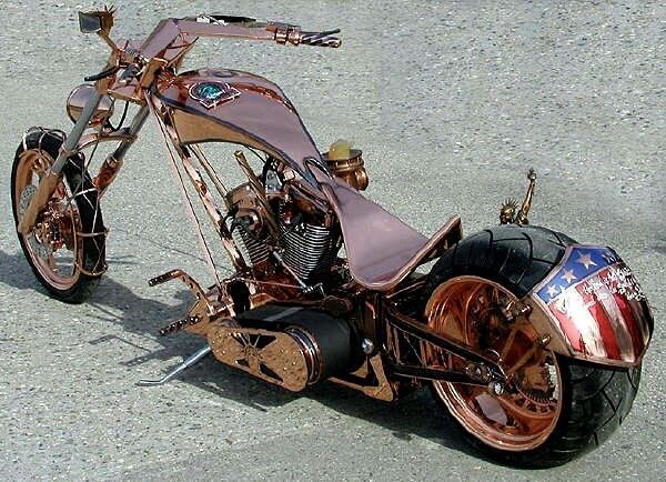 an unusual looking motorcycle is parked on the pavement