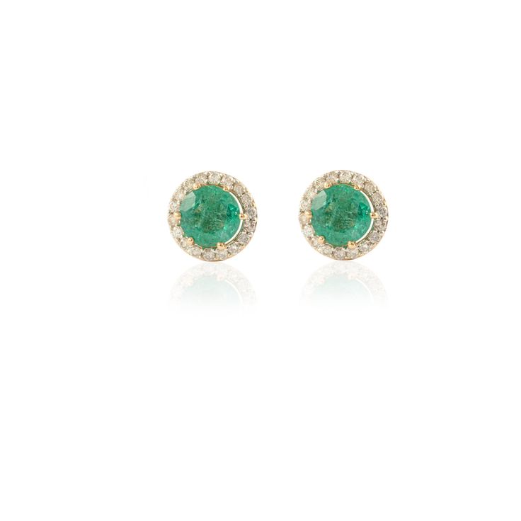 This pair of earrings is set in 14K Yellow Gold, studded with green emeralds (with slight Inclusions) & Diamonds. An ideal gift for your loved ones. -Material - 14K Solid Yellow Gold -Gemstone - Natural Emerald & Diamond -Gemstone weight - 1.530 ct -Diamond Weight - 0.370 ct -Gross weight - 3.0 grams Wearing an emerald stone, also known as panna or zammrud brings in intellectual progress. Natural intelligence and intellect is the domain of Planet Mercury and enhancing this planets power Green Round Earrings With Halo Setting, Classic Green Halo Earrings, Green Halo Design Fine Jewelry Earrings, Green Diamond Earrings With Prong Setting, Green Round Diamond Earrings Fine Jewelry, Green Diamond Earrings With Halo Design For Anniversary, Classic Green Diamond Earrings With Halo Design, Green Diamond Halo Design Earrings, Green Halo Diamond Earrings For Anniversary