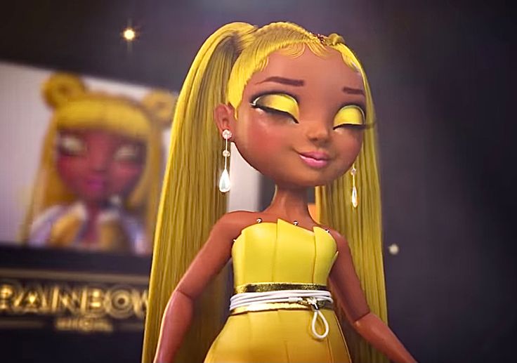 a doll with long blonde hair and bright yellow eyes stands in front of a screen