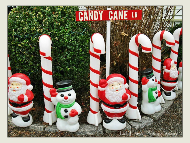 candy canes are lined up in the shape of santa claus and snowmen, along with a sign that says candy cane lane