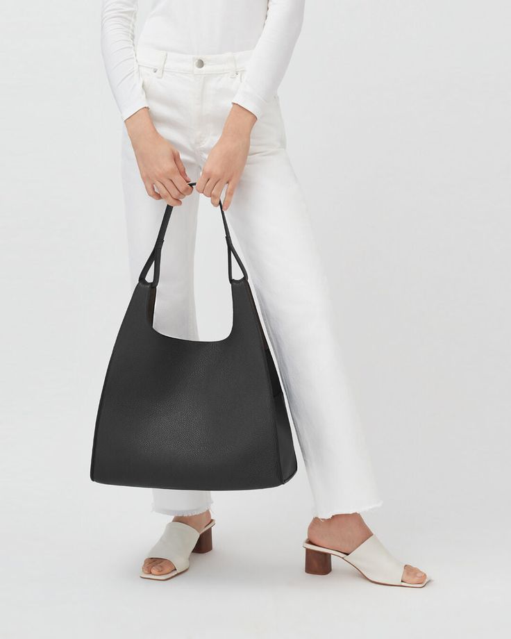 A modern and unique marriage of the classic shoulder bag and the quotidian shopping bag, with a soft structure, to elegantly accompany you through everyday activities. Small Leather Accessories, Leather Industry, Zippered Tote, Leather Conditioner, Backpack Travel Bag, Mini Tote, Shopping Tote, Small Leather Goods, Soft Suede