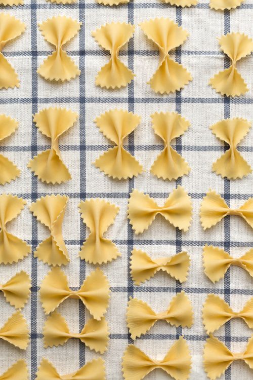 several pieces of uncooked pasta on a checkered table cloth