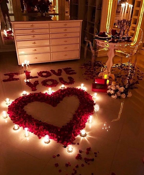 valentine's day decoration with candles and roses in the shape of a love heart