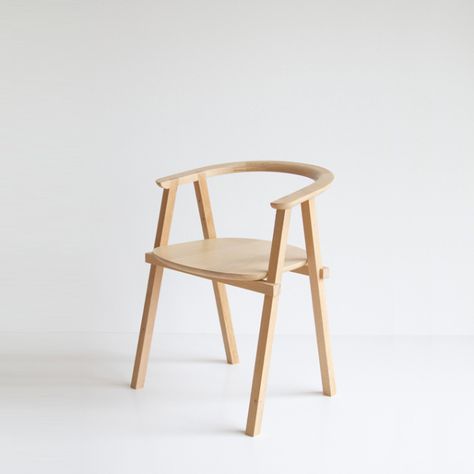 a wooden chair sitting on top of a white floor