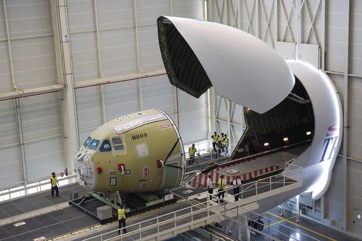 an airplane being worked on in a hangar