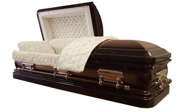 a large brown casket with a white blanket on top