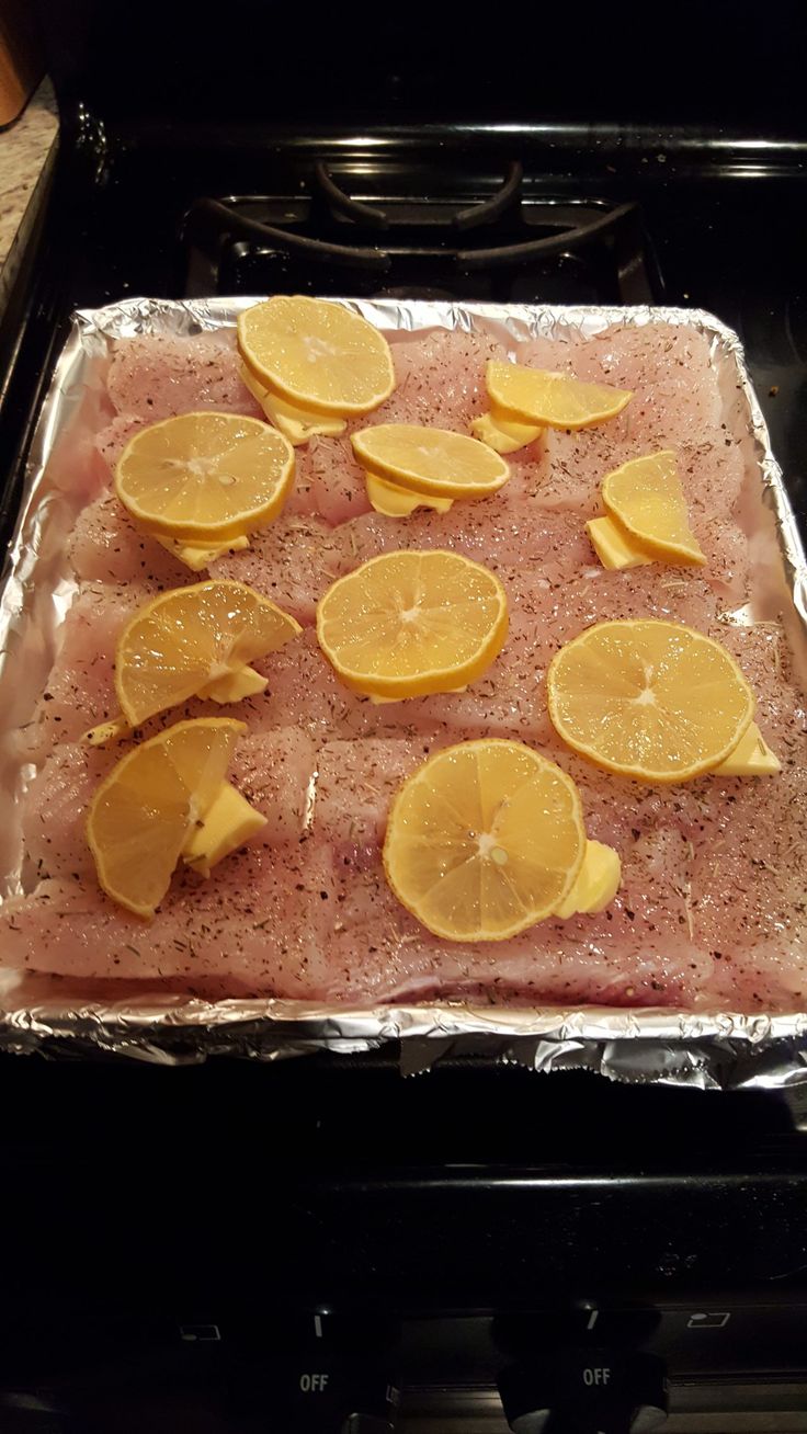 the meat is covered with lemons and has been placed on top of an oven