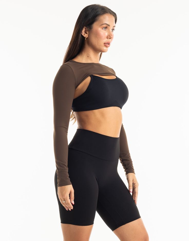 Functional athleisure at its finest. The Range Long Sleeve is the perfect garment to complete your workout look. Featuring a slim fit, super cropped length, the Range Long Sleeve is perfect to throw over your favorite ECHT sportsbra or with Range V3 Sportsbra as shown and matching Range Leggings! - Super Cropped Length - perfect with high-rise pants - Mix and match with your favourite ECHT sportsbra - Fabric: Super soft and breathable - Slim fit skims your body - Silver logo on sleeve - Breathability and ease of movement 81% Nylon, 19% Spandex Range V3 Sportsbra is sold separately. Stretch Crop Top For Pilates, Fitted Cropped Crop Top For Pilates, Athleisure Cropped Fitted Sports Bra, Athleisure Fitted Cropped Sports Bra, Fitted Athleisure Crop Top Sports Bra, Fitted Crop Top Activewear For Pilates, Medium Support Cropped Top For Pilates, Black Compressive Crop Top Activewear, Elastane Cropped Tops For Workout