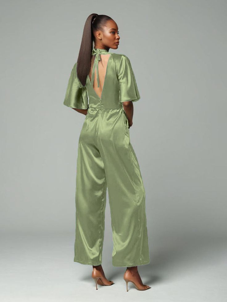 This soft satin jumpsuit features a flattering v-neck design, making it the perfect choice for mothers of the bride. Its dress pantsuit style provides comfort and elegance, while its high-quality material ensures a polished look. Stay stylish and comfortable on that special day with our jumpsuit. Formal Jumpsuits For Women Wedding, Dress Pantsuit, Elegant Jumpsuit, Dress Pant Suit, Satin Jumpsuit, Formal Jumpsuit, Jumpsuit Elegant, Mother Of The Bride Dress, Dress With Tie