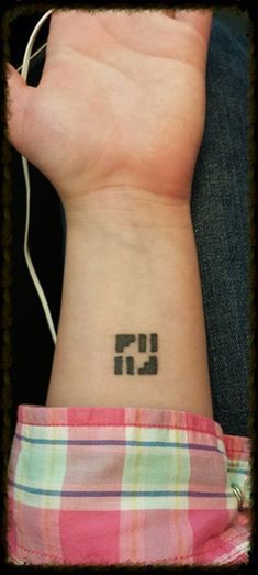 a person with a small wrist tattoo on their left arm and the number twenty nine