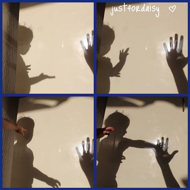 the shadow of a child's hand reaching out for something with his arms and hands