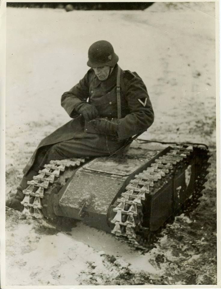 a man sitting on top of a tank in the snow