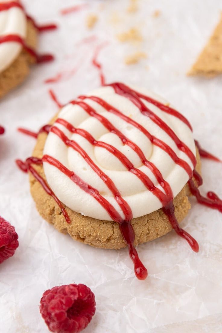 raspberry shortbreads with whipped cream and drizzled on them