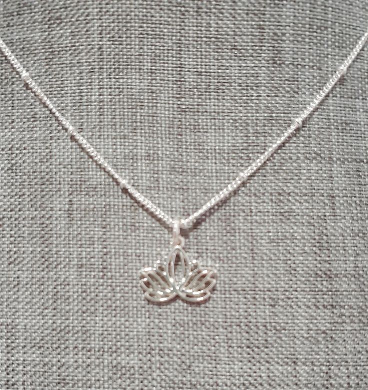 This simple silver necklace features an 18-inch chain crafted from high-quality silver plate, providing a sleek and timeless look. Adorned with a delicate silver plate lotus flower charm, the necklace symbolizes purity and new beginnings, adding a touch of serene beauty to your ensemble. The chain is equipped with a 2-inch extender, allowing you to adjust the length for a perfect fit or layered look. Whether worn alone for a subtle statement or paired with other pieces, this necklace is a versat Lotus Flower Necklace, Silver Necklace Simple, Layered Look, Lotus Flower, Flower Necklace, Lotus, Charm Necklace, Necklace Etsy, Halloween Shopping