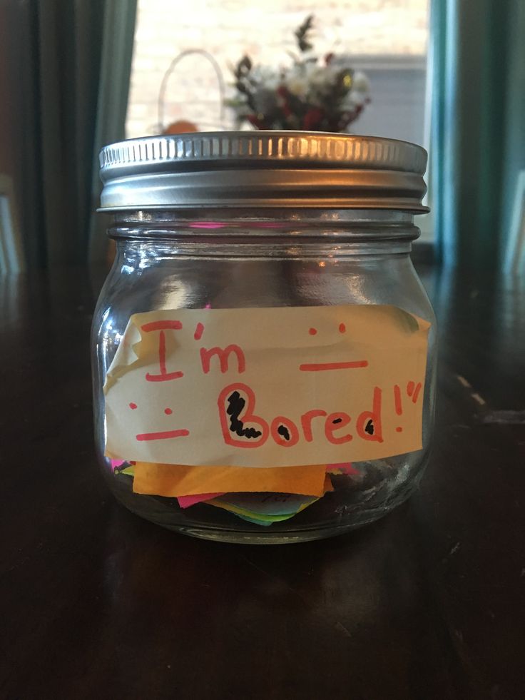 a jar filled with sticky notes sitting on top of a table